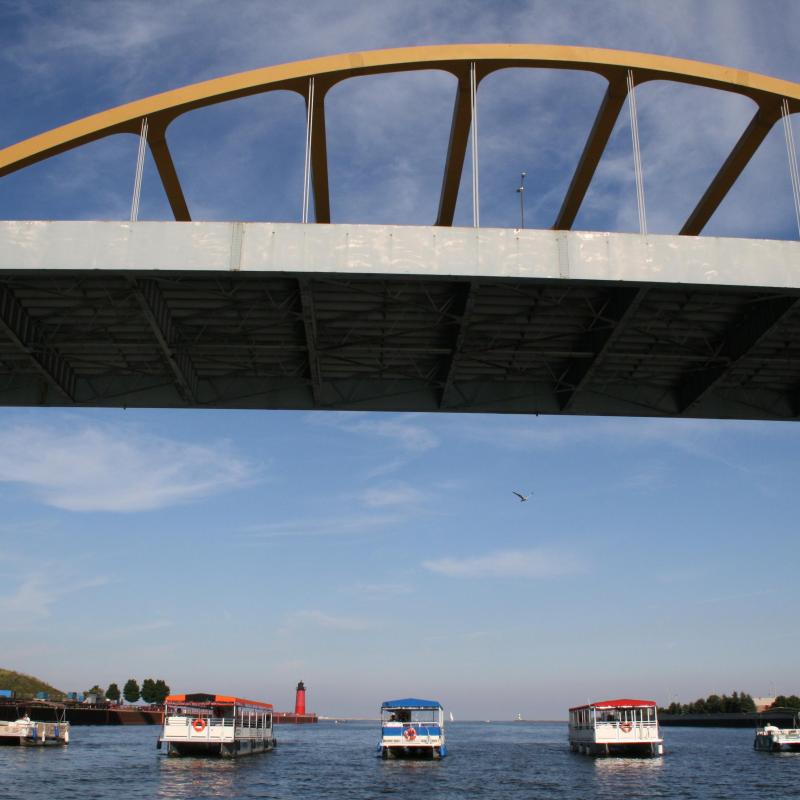 Riverwalk Boat Tours' boats under a bridge